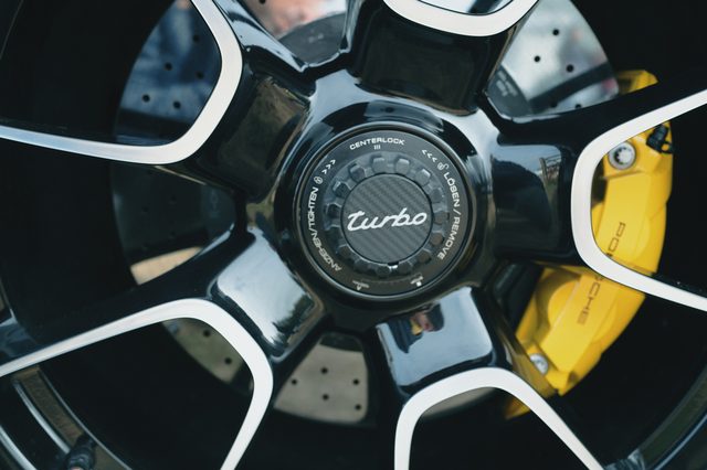A Porsche Turbo centre-lock wheel with a yellow brake caliper.