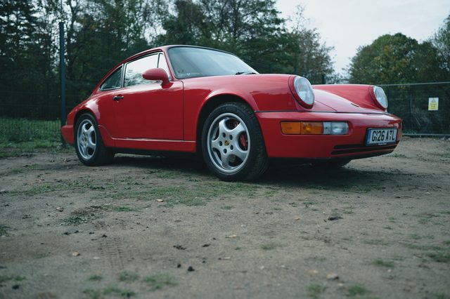A red classic Porsche 911, front three-quarter.