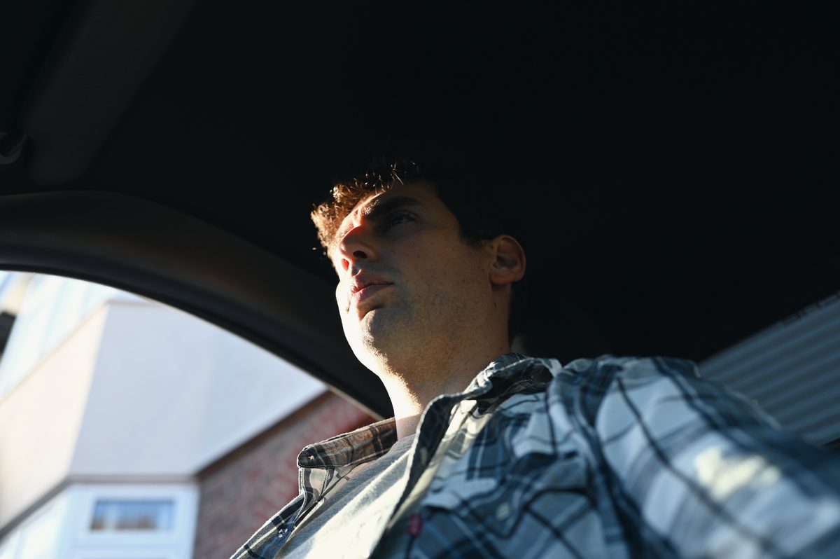David in the driver's seat, seen from low down by the door.