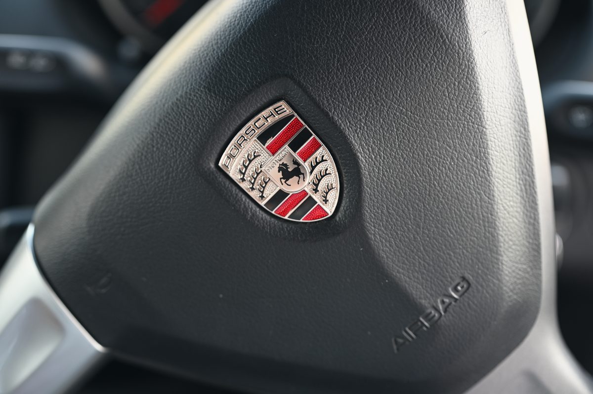 The Porsche crest on the steering wheel.