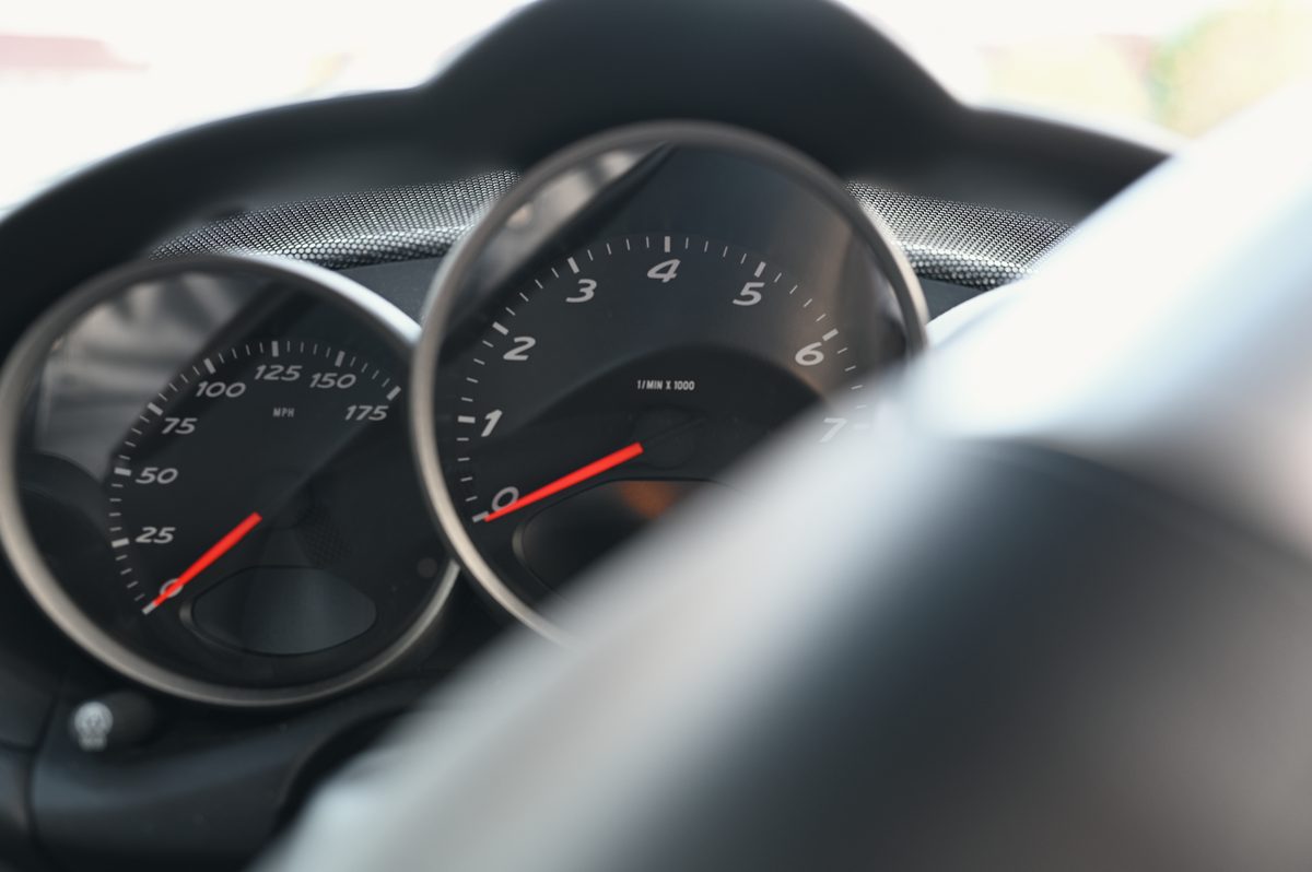 The speedometer and rev counter behind the wheel rim.
